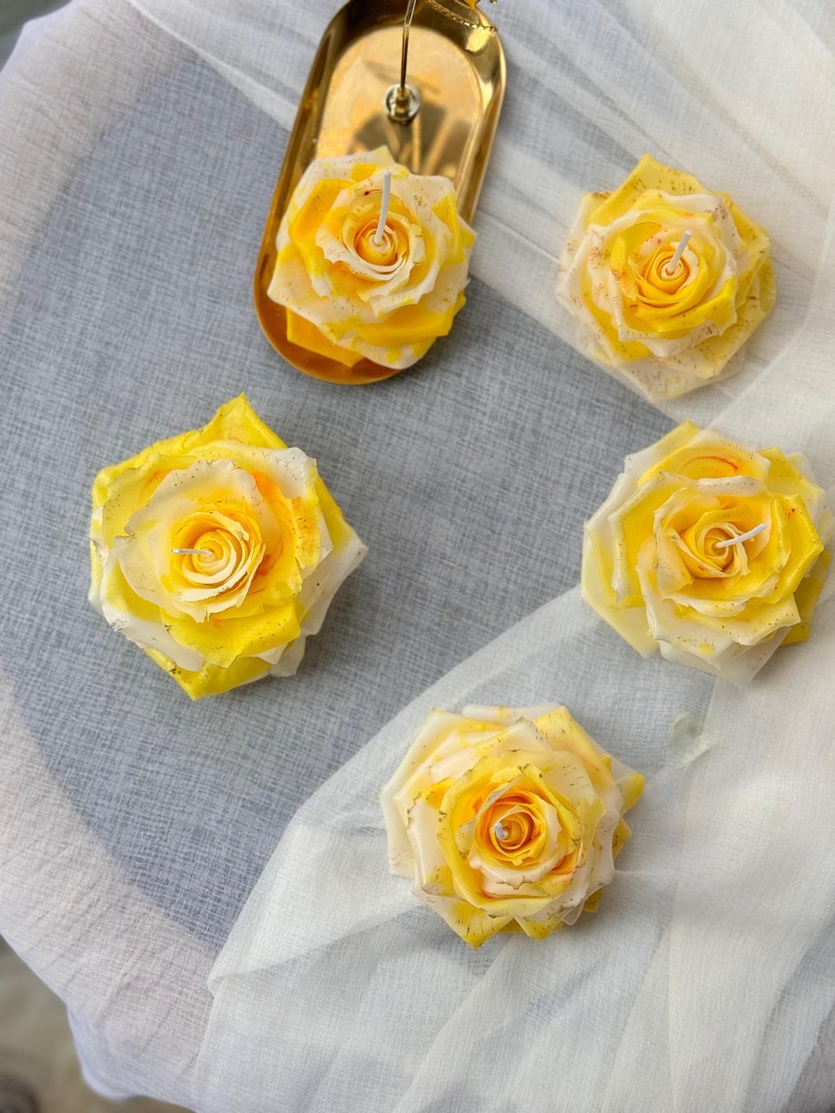 A detailed floral candle with layered petals.